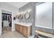 Modern bathroom with double vanity, decorative lighting, and spacious walk-in closet at 2405 W Memorial Dr, Anthem, AZ 85086
