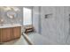 Stylish bathroom featuring wood vanity, quartz counters, and a sleek tile shower at 2405 W Memorial Dr, Anthem, AZ 85086