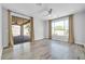 Light filled bedroom with sliding glass doors, luxury vinyl flooring, and modern ceiling fan at 2405 W Memorial Dr, Anthem, AZ 85086
