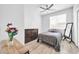 Cozy bedroom featuring a ceiling fan, light-filled window, and wood-style flooring at 2405 W Memorial Dr, Anthem, AZ 85086