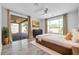 Bright bedroom featuring a king-size bed, sliding glass doors, and modern ceiling fan at 2405 W Memorial Dr, Anthem, AZ 85086