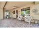 Covered patio featuring brick pavers, ceiling fan, and seating with a view of backyard at 2405 W Memorial Dr, Anthem, AZ 85086