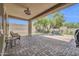 Covered patio featuring brick pavers, ceiling fan, and casual seating, with view of the yard at 2405 W Memorial Dr, Anthem, AZ 85086