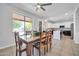 Charming dining area with rustic wooden table, overlooking the kitchen and backyard at 2405 W Memorial Dr, Anthem, AZ 85086
