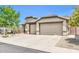 Inviting single-story home showcasing a well-kept xeriscaped front yard and a convenient three-car garage at 2405 W Memorial Dr, Anthem, AZ 85086