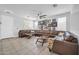Bright living room showcasing tile floors, a large sectional sofa, and ample wall decor at 2405 W Memorial Dr, Anthem, AZ 85086
