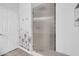 Bathroom featuring frameless shower with textured glass, decorative tile, and toiletry hooks at 2405 W Memorial Dr, Anthem, AZ 85086