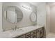 Bathroom with double sinks, granite countertops, modern fixtures and round decorative mirrors at 2605 E Fountain St, Mesa, AZ 85213