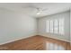 Bedroom with hardwood floors, a ceiling fan and plantation shutters on the window at 2605 E Fountain St, Mesa, AZ 85213