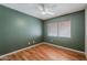 Bedroom with hardwood floors, a ceiling fan and a window overlooking the side yard at 2605 E Fountain St, Mesa, AZ 85213