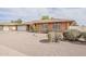 Charming single-story brick home with an attached two-car garage and desert landscaping, creating a welcoming curb appeal at 2605 E Fountain St, Mesa, AZ 85213