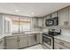 Modern kitchen with stainless steel appliances, granite countertops, and backyard views at 2605 E Fountain St, Mesa, AZ 85213