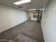 Spacious basement with neutral carpet, white walls, and unique spiral staircase at 3062 N 42Nd Ave, Phoenix, AZ 85019