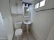 Cozy bathroom featuring tiled floors, a pedestal sink, and white fixtures at 3062 N 42Nd Ave, Phoenix, AZ 85019