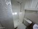 Updated bathroom features white textured tile shower and sleek design at 3062 N 42Nd Ave, Phoenix, AZ 85019