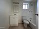 Clean bathroom with white fixtures, vanity, and tiled floors offers a refreshing space at 3062 N 42Nd Ave, Phoenix, AZ 85019