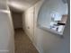 Bright hallway leading to the kitchen with white cabinets, tiled floors, and ample storage space at 3062 N 42Nd Ave, Phoenix, AZ 85019