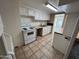 An open kitchen shows an electric stove, white cabinetry, and tiled flooring at 3062 N 42Nd Ave, Phoenix, AZ 85019