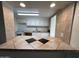An open kitchen with white cabinets and tiled countertops is shown at 3062 N 42Nd Ave, Phoenix, AZ 85019