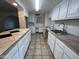 A large kitchen showcases white cabinets, tiled floors, and an island at 3062 N 42Nd Ave, Phoenix, AZ 85019