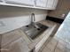 A sleek stainless steel sink with a modern faucet is set in a tiled countertop at 3062 N 42Nd Ave, Phoenix, AZ 85019