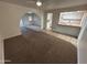 Cozy living room with carpet, skylight, and an archway leading to another room at 3062 N 42Nd Ave, Phoenix, AZ 85019