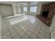 Spacious living room with tile floor, brick fireplace, and natural light at 3062 N 42Nd Ave, Phoenix, AZ 85019