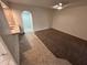 A spacious carpeted room leads into the kitchen and tiled room at 3062 N 42Nd Ave, Phoenix, AZ 85019