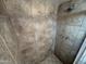 Close up of the tiled shower with bronze fixtures and shower head at 3062 N 42Nd Ave, Phoenix, AZ 85019