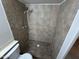 Walk-in shower features brown tile and a shower head on an adjustable bar at 3062 N 42Nd Ave, Phoenix, AZ 85019