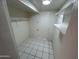 Spacious walk-in closet with white tile floor and built-in shelving at 3062 N 42Nd Ave, Phoenix, AZ 85019