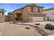 Charming two-story home with a stucco exterior and well-maintained desert landscaping in the front yard at 4323 E Dublin St, Gilbert, AZ 85295