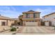 Two-story home featuring a two-car garage, well-maintained facade, and desert landscaping at 4323 E Dublin St, Gilbert, AZ 85295
