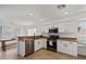 Bright kitchen with white cabinets, granite countertops, and stainless steel appliances at 4323 E Dublin St, Gilbert, AZ 85295