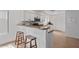Modern kitchen featuring sleek countertops, white cabinetry, and barstool seating for casual dining at 4323 E Dublin St, Gilbert, AZ 85295