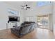 Bright living room features high ceilings, a ceiling fan, and sliding glass doors leading to the pool at 4323 E Dublin St, Gilbert, AZ 85295