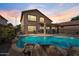 Inviting backyard pool area with rocks and a covered patio perfect for relaxing and entertaining outdoors at 4323 E Dublin St, Gilbert, AZ 85295