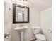 Cozy bathroom with a pedestal sink, a standard toilet, and a decorative mirror at 4380 E Renee Dr, Phoenix, AZ 85050