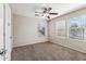 Bright bedroom with a ceiling fan and two windows, offering plenty of natural light at 4380 E Renee Dr, Phoenix, AZ 85050