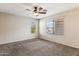 Bedroom with a ceiling fan and two windows offering natural light and views of the neighborhood at 4380 E Renee Dr, Phoenix, AZ 85050