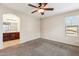 Neutral bedroom with a ceiling fan and an archway to the bathroom, enhancing the open feel at 4380 E Renee Dr, Phoenix, AZ 85050