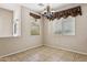 Dining room featuring tile flooring, two windows, and elegant chandelier at 4380 E Renee Dr, Phoenix, AZ 85050