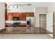 Kitchen showcasing granite countertops, stainless steel appliances, and a pantry at 4380 E Renee Dr, Phoenix, AZ 85050