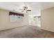 Carpeted living room featuring a view of the dining room and the front door at 4380 E Renee Dr, Phoenix, AZ 85050