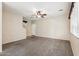 Spacious carpeted living room with a ceiling fan and a view to the stairs at 4380 E Renee Dr, Phoenix, AZ 85050