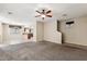 Open living room showcasing a carpeted area, a view of the staircase, and an adjacent tiled dining area at 4380 E Renee Dr, Phoenix, AZ 85050