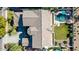 Aerial view of home showcasing the roof, pool, and lush landscaping at 4497 E Carriage Way, Gilbert, AZ 85297