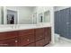 Bathroom featuring dual sinks with wood cabinets and a shower/tub combo at 4497 E Carriage Way, Gilbert, AZ 85297