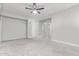 Spacious, carpeted bedroom with neutral walls and a ceiling fan at 4497 E Carriage Way, Gilbert, AZ 85297