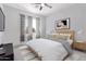 Cozy bedroom with modern decor, window with patterned curtains, and carpeted floor at 4497 E Carriage Way, Gilbert, AZ 85297